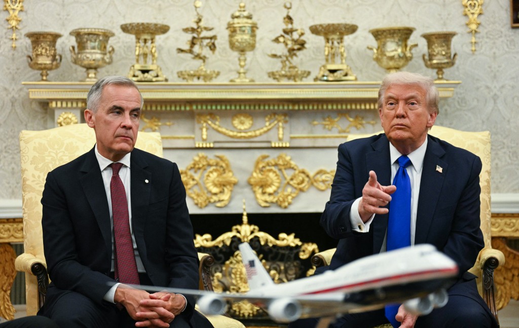 US President Donald Trump meets with Canadian Prime Minister Mark Carney in the Oval Office of the White House in Washington, DC, on October 7, 2025. (Photo by Jim WATSON / AFP)