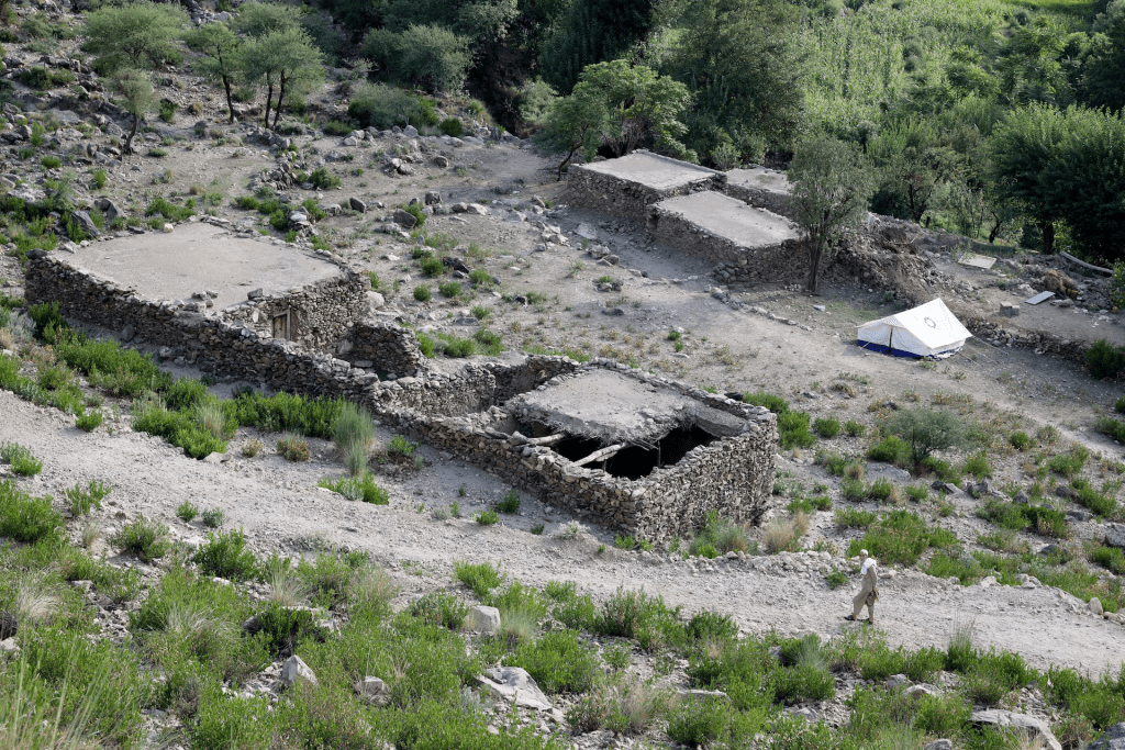 An Afghan man walks next to a damaged house following a deadly earthquake that struck Afghanistan's Kunar and Nangarhar provinces, in Nurgal district, Kunar province, Afghanistan, September 4, 2025. REUTERS/Sayed Hassib
