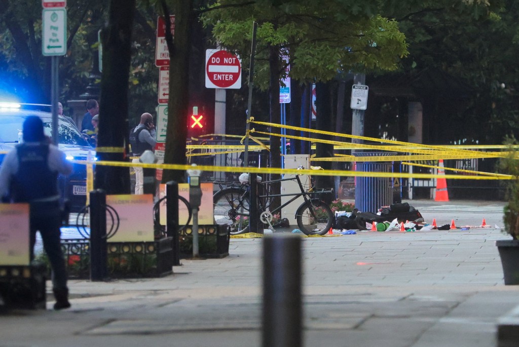 Marker cones over potential evidence behind yellow tape cordoning an area, after a shooting incident near the White House, in Washington, D.C., U.S., May 23, 2026. (Reuters)