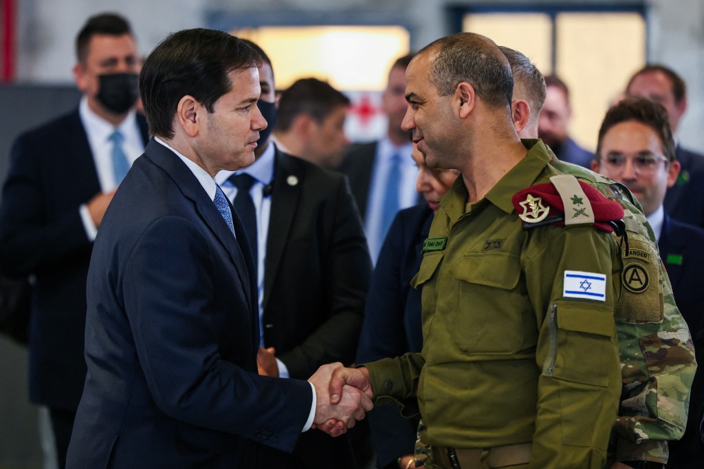 Photo by FADEL SENNA / POOL / AFP. US Secretary of State Marco Rubio shakes hands with Israeli Brigadier General Yaakov Dolf as he visits the Civil-Military Coordination Center in southern Israel on October 24, 2025.