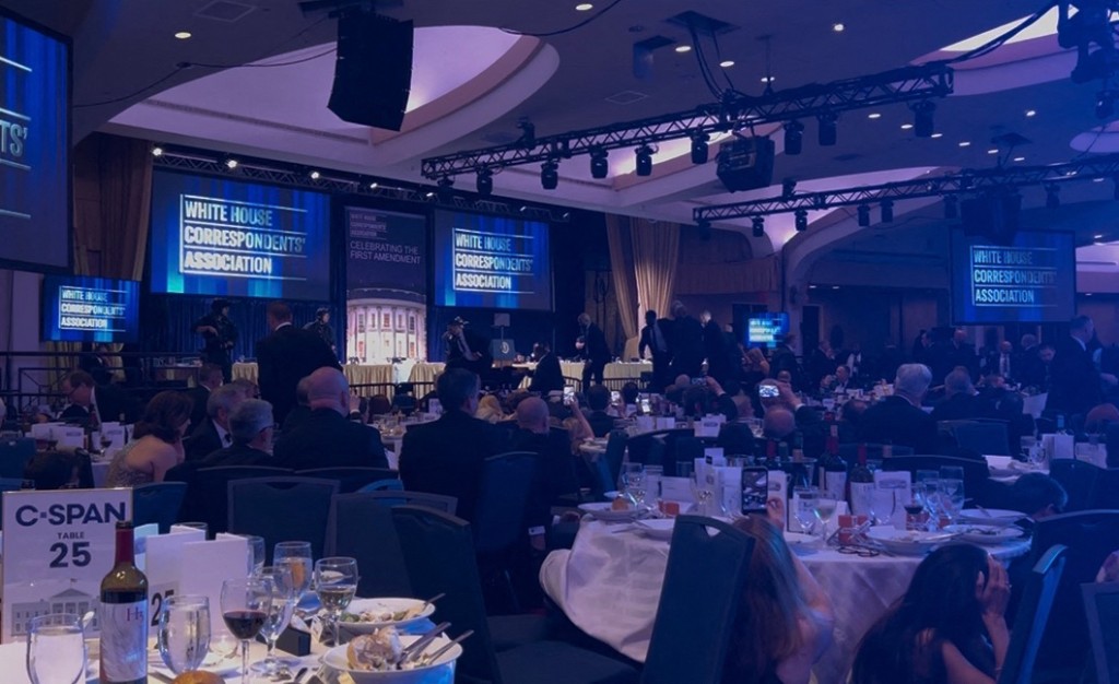 Photo by DANNY KEMP / AFP  A screen grab taken from a video filmed by an AFP reporter shows armed agents moving to the stage after loud bangs were heard during the White House Correspondents' dinner at the Washington Hilton in Washington, DC, on April 25, 2026.