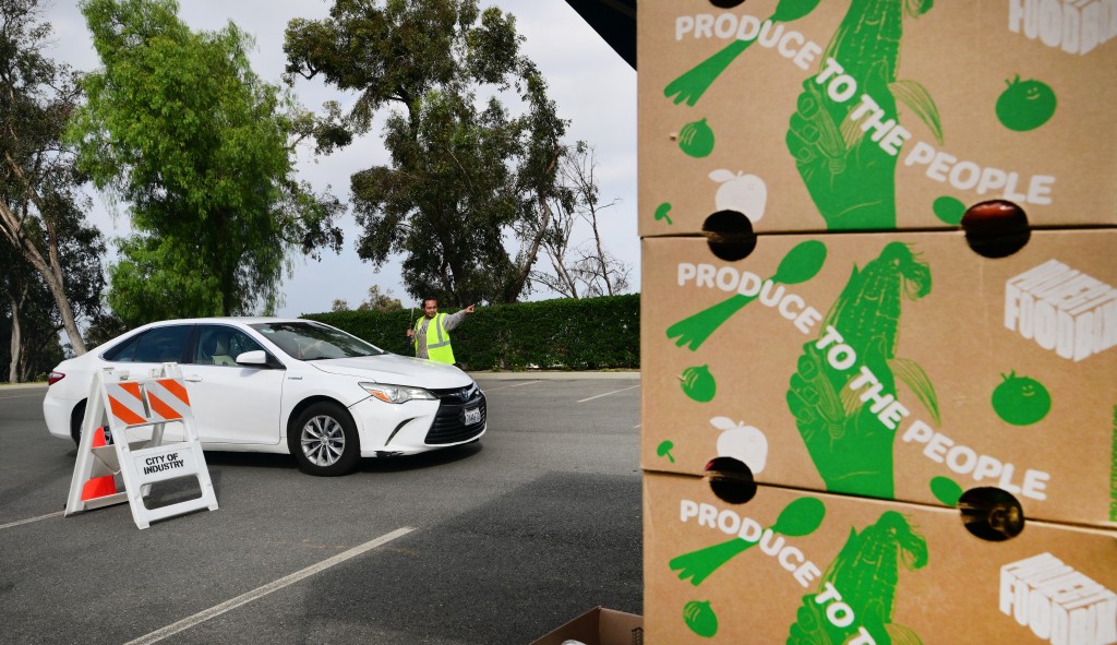 Photo by FREDERIC J. BROWN / AFP A driver is directed to receive free food from the Los Angeles Regional Food Bank on November 5, 2025, in City of Industry, California.