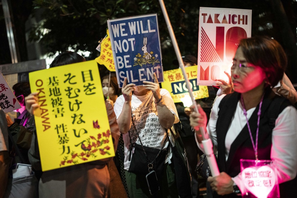 Photo by YUICHI YAMAZAKI / AFP  People protest against the killing of a woman in Okinawa allegedly committed by a US Marine Corps member, in front of the Prime Minister's Office in Tokyo on October 5, 2026.