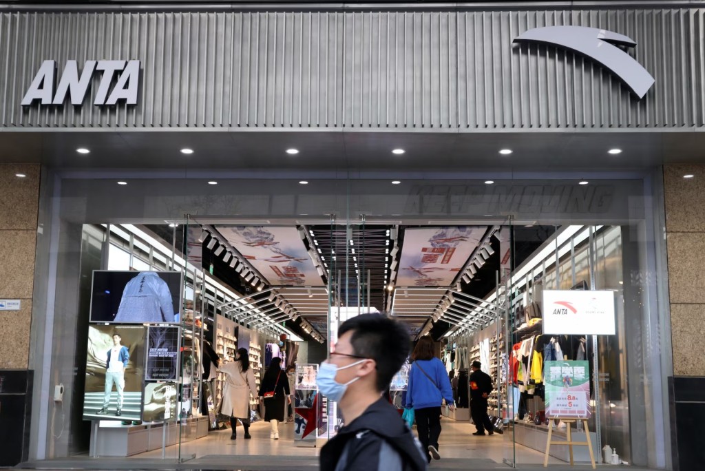 A man walks past a store of Chinese sportswear firm Anta Sports at a shopping mall in Beijing, China March 25, 2021. REUTERS