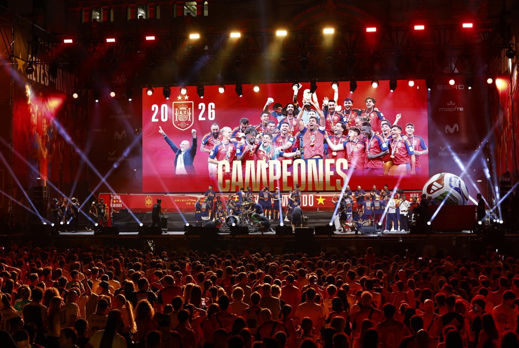 Photo by OSCAR DEL POZO / AFP Spain's players celebrate on a stage at Cibeles Square in Madrid on July 20, 2026, one day after winning their second World Cup title following a 1-0 victory against Argentina.