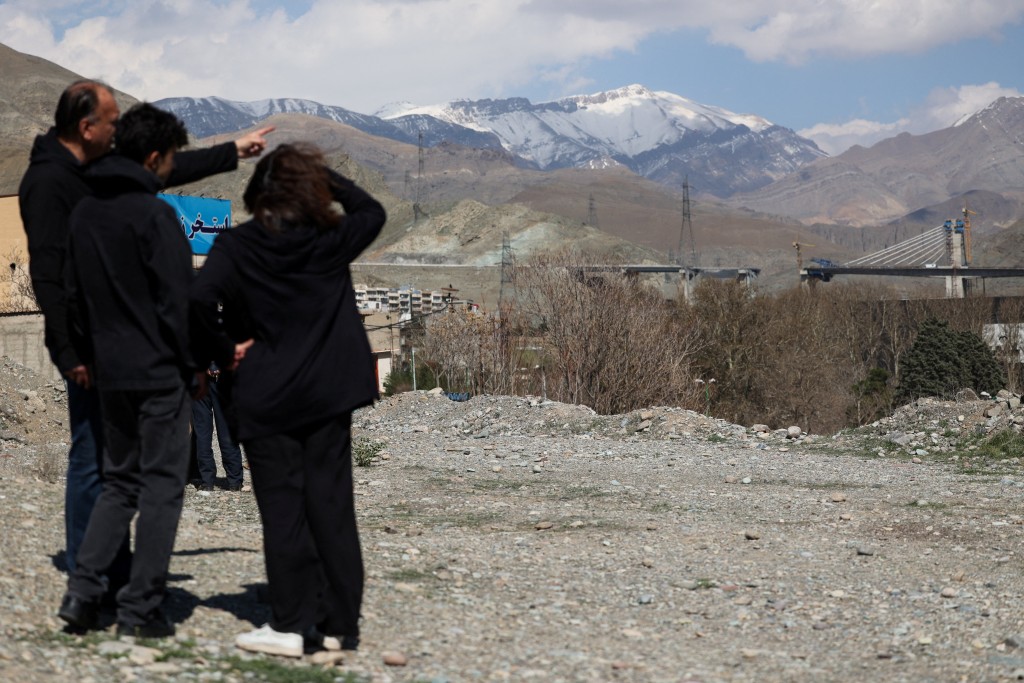 Gathered onlookers observe the B1 bridge damaged by a strike, as the U.S.-Israeli conflict with Iran continues, in Karaj, Iran, April 3, 2026. Majid Asgaripour/WANA (West Asia News Agency) via REUTERS