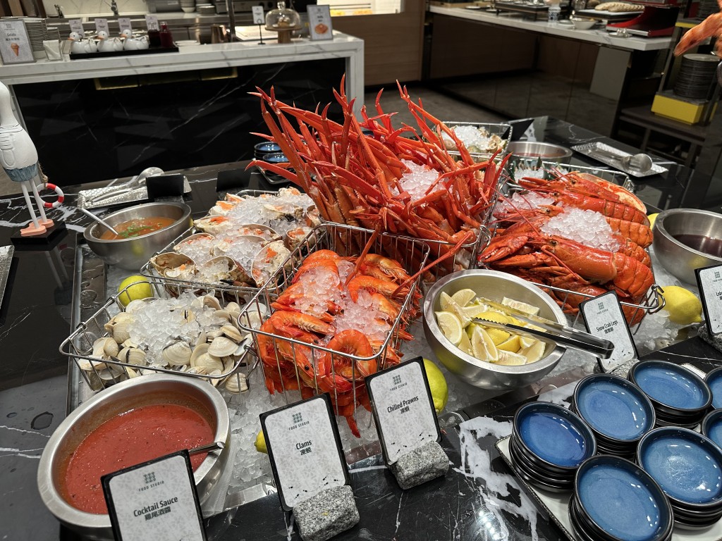 Seafood on ice selection featuring Brown Crab, Snow Crab Legs, Sea Whelk, Mussels, Shrimp and Clams.