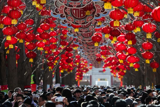 People gather at a holiday market in a park during Lunar New Year celebrations marking the Year of the Horse, in Beijing, China, February 18, 2026. REUTERS/Maxim Shemetov 
