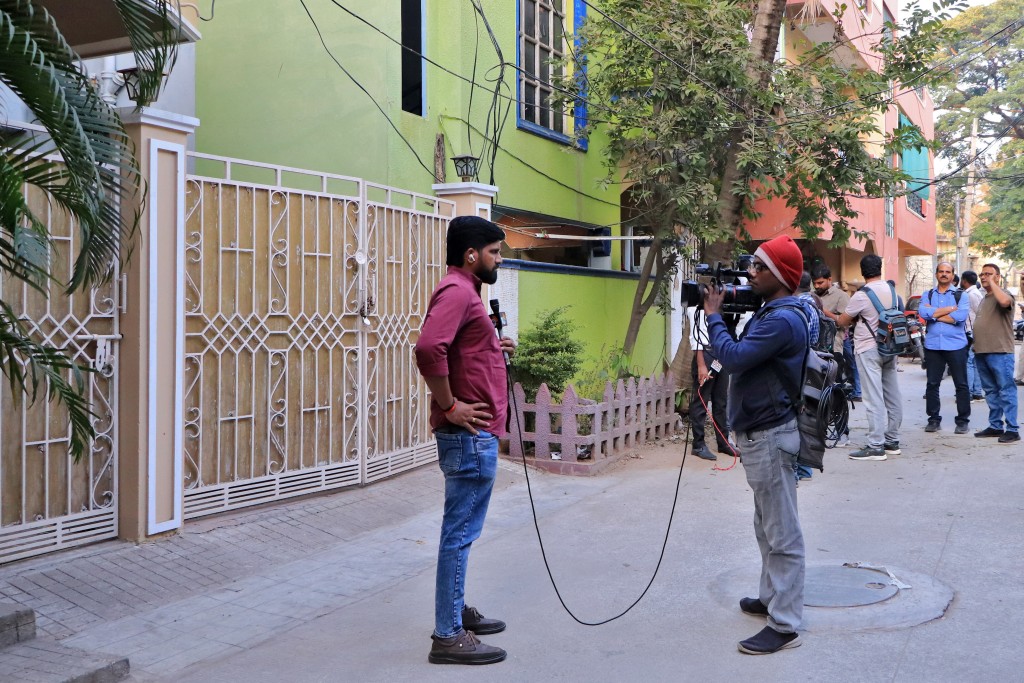 Members of the media work in front of the house of the family of a suspected gunman who was shot dead by police during a shooting at a Hanukkah event at Sydney's Bondi Beach, in Hyderabad, India, December 16, 2025. REUTERS/Almaas Masood