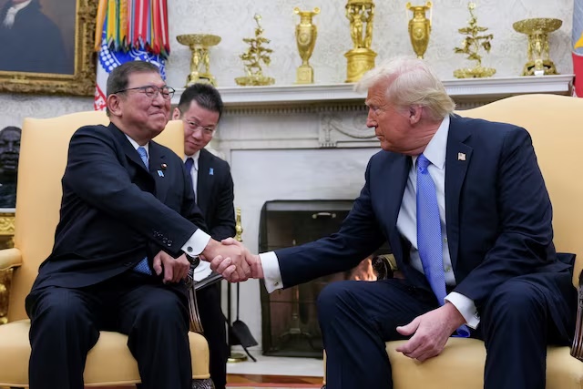 U.S. President Donald Trump shakes hands with Japan's Prime Minister Shigeru Ishiba at the White House in Washington, U.S., February 7, 2025. REUTERS/Kent Nishimura/ File Photo 