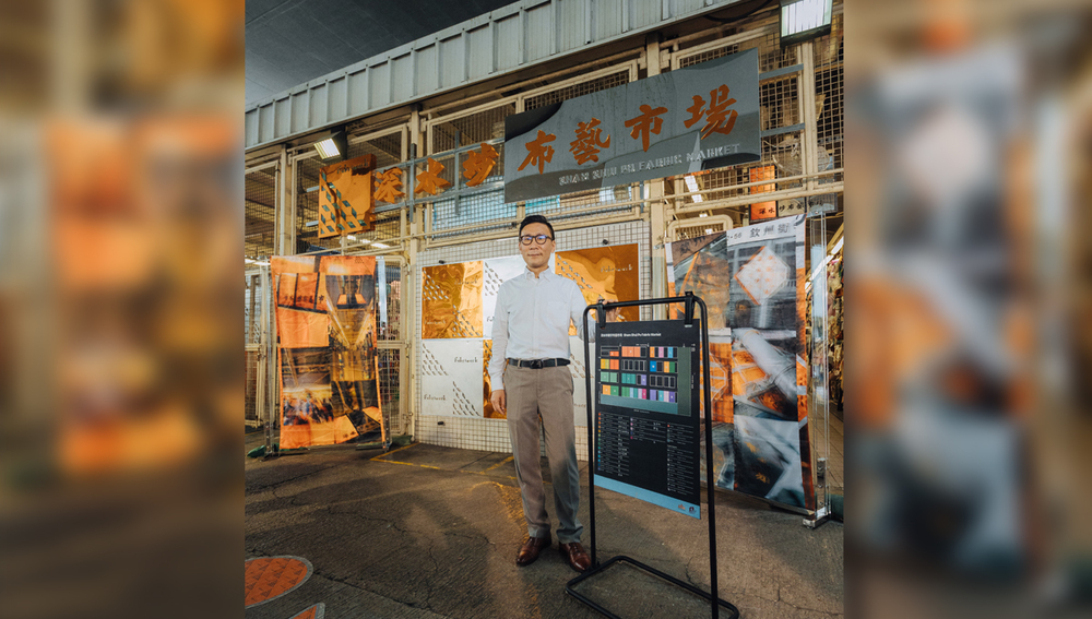 Paul Wong Yan-yin presents the new sign at the market entrance
