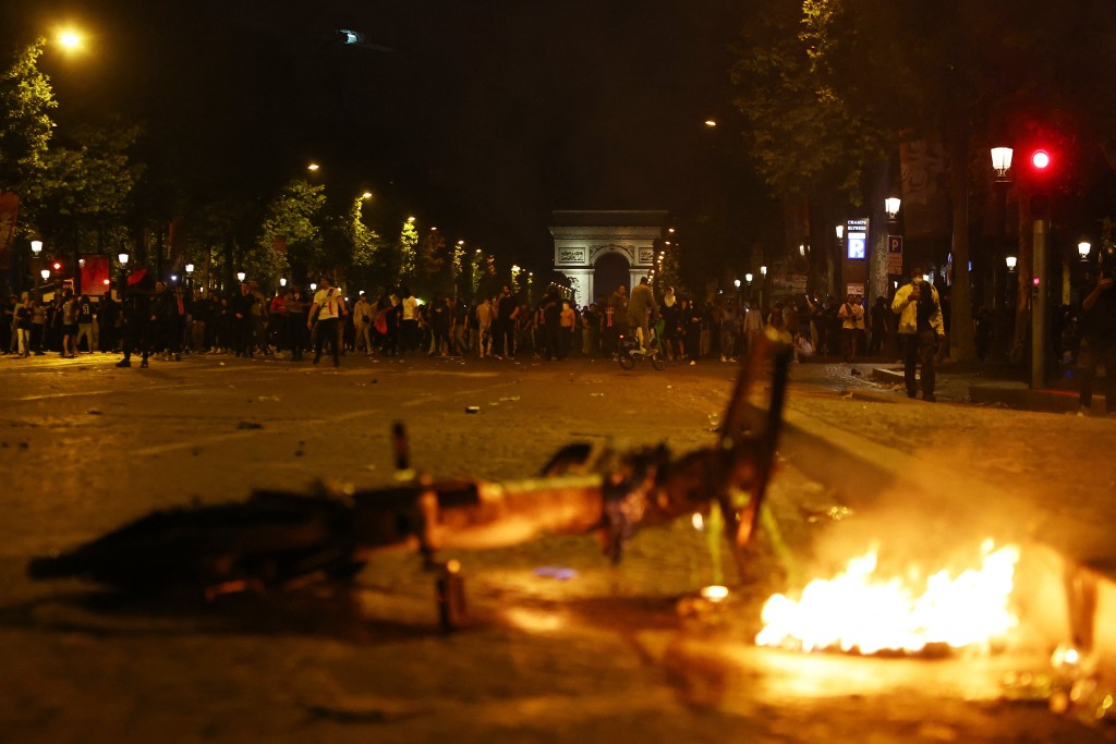 A burning bike is seen on the Champs Elysees avenue near the Arc de Triomphe after Paris St Germain won the Champions League. (Reuters)