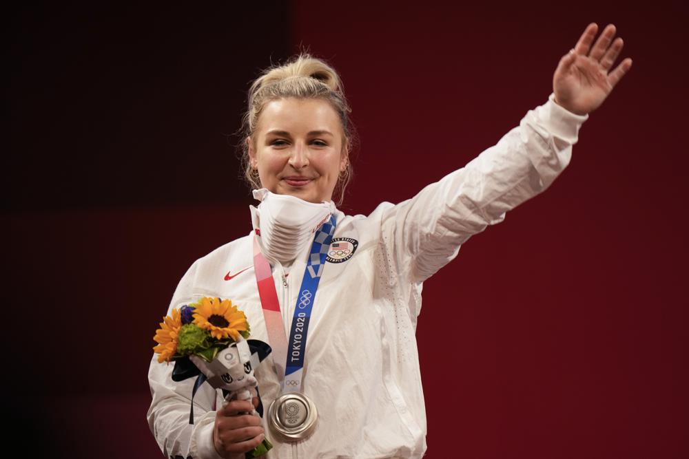 Katherine Elizabeth Nye of the United States waves after from the podium after receiving the silver medal for women's 76kg weightlifting, at the 2020 Summer Olympics, Sunday, Aug. 1, 2021, in Tokyo, Japan. Katherine Elizabeth Nye of the United States waves after from the podium after receiving the silver medal for women's 76kg weightlifting, at the 2020 Summer Olympics, Sunday, Aug. 1, 2021, in Tokyo, Japan.