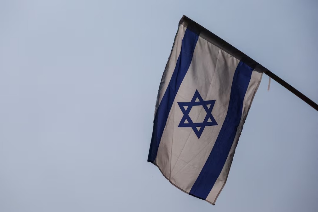 An Israeli flag is seen at the entrance to a school in Kibbutz Amir near Israel's border with Lebanon, in northern Israel, October 10, 2023. REUTERS/Lisi Niesner