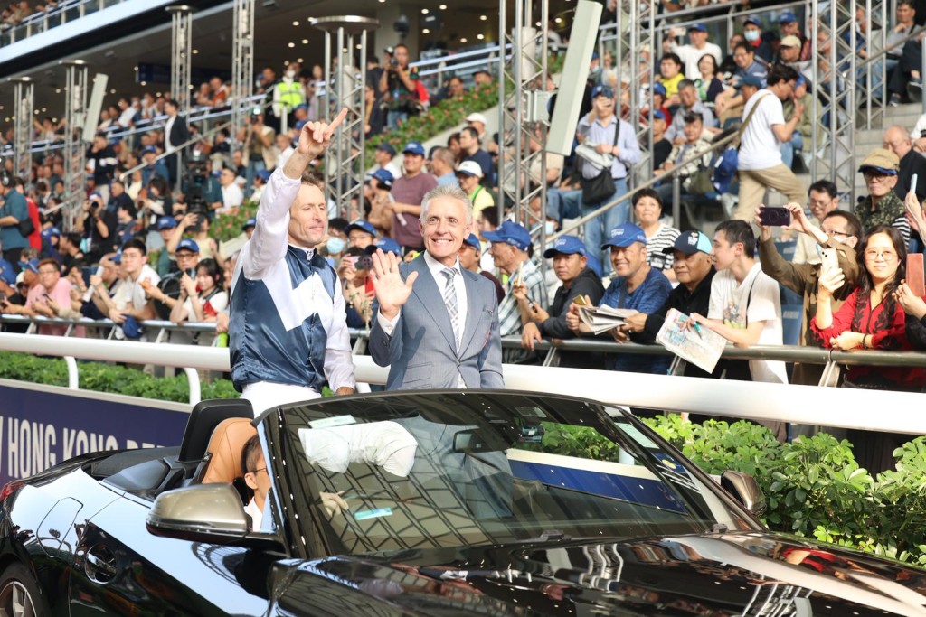 Hugh Bowman and Mark Newnham parade in front of the crowd in a BMW after winning the Hong Kong Derby with Invincible Ibis. Sing Tao