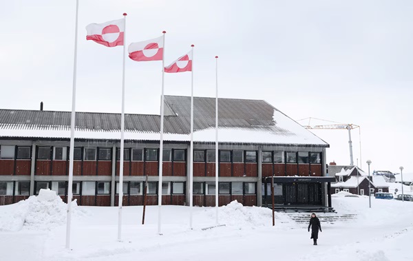 A woman walks past Greenland's parliament Inatsisartut in Nuuk, Greenland, March 28, 2025. REUTERS/Leonhard Foeger/File Photo 
