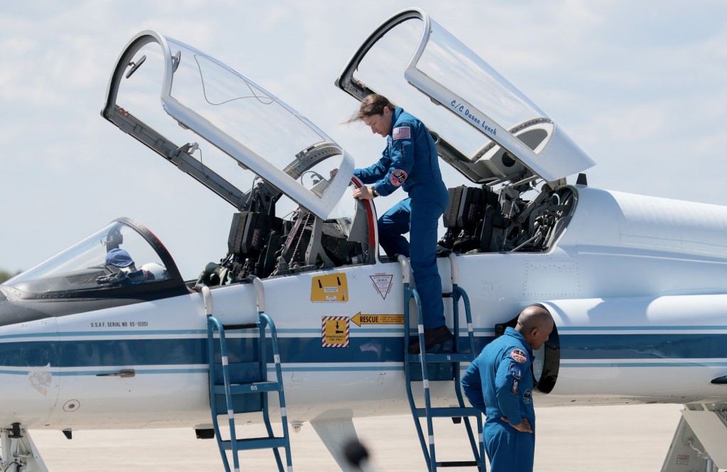 Artemis II crew members pilot Victor Glover and mission specialist Christina Koch arrive at the Kennedy Space Center in a T-38 jet on March 27, 2026 in Cape Canaveral, Florida. The astronauts arrived to begin preparations for an April 1, 2026 launch for a 10-day mission, which will take them around the Moon and back to Earth. Joe Raedle/Getty Images/AFP