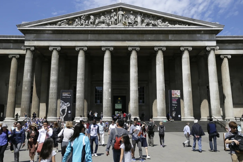 FILE - Visitors walk outside the British Museum in Bloomsbury, London, Friday, June 26, 2015. The British Museum is suing a former curator alleged to have stolen almost 2,000 artifacts from its collections and offered them for sale online. Peter Higgs was fired in July 2023 after more than 1,800 items were discovered to be missing. (AP Photo/Tim Ireland, File) FILE - Visitors walk outside the British Museum in Bloomsbury, London, Friday, June 26, 2015. The British Museum is suing a former curator alleged to have stolen almost 2,000 artifacts from its collections and offered them for sale online. Peter Higgs was fired in July 2023 after more than 1,800 items were discovered to be missing. (AP Photo/Tim Ireland, File)