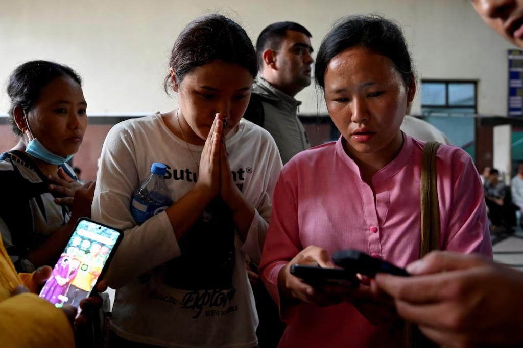 Family members check a list of people who were injured following a deadly flash flood, outside a trauma centre of Bir Hospital in Kathmandu, Nepal, August 26, 2026. REUTERS/Monika Malla