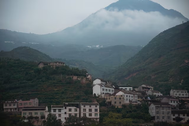 Houses are seen at the foot of a mountain in Yaan, Sichuan province, China September 9, 2020. Picture taken September 9, 2020. REUTERS/Tingshu Wang