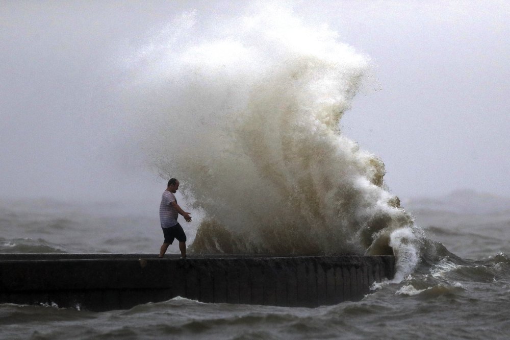 A wave crashes as a man stands on a jetty near Orleans Harbor in Lake Pontchartrain in New Orleans, Sunday, June 7, 2020, as Tropical Storm Cristobal approaches the Louisiana Coast. A wave crashes as a man stands on a jetty near Orleans Harbor in Lake Pontchartrain in New Orleans, Sunday, June 7, 2020, as Tropical Storm Cristobal approaches the Louisiana Coast.
