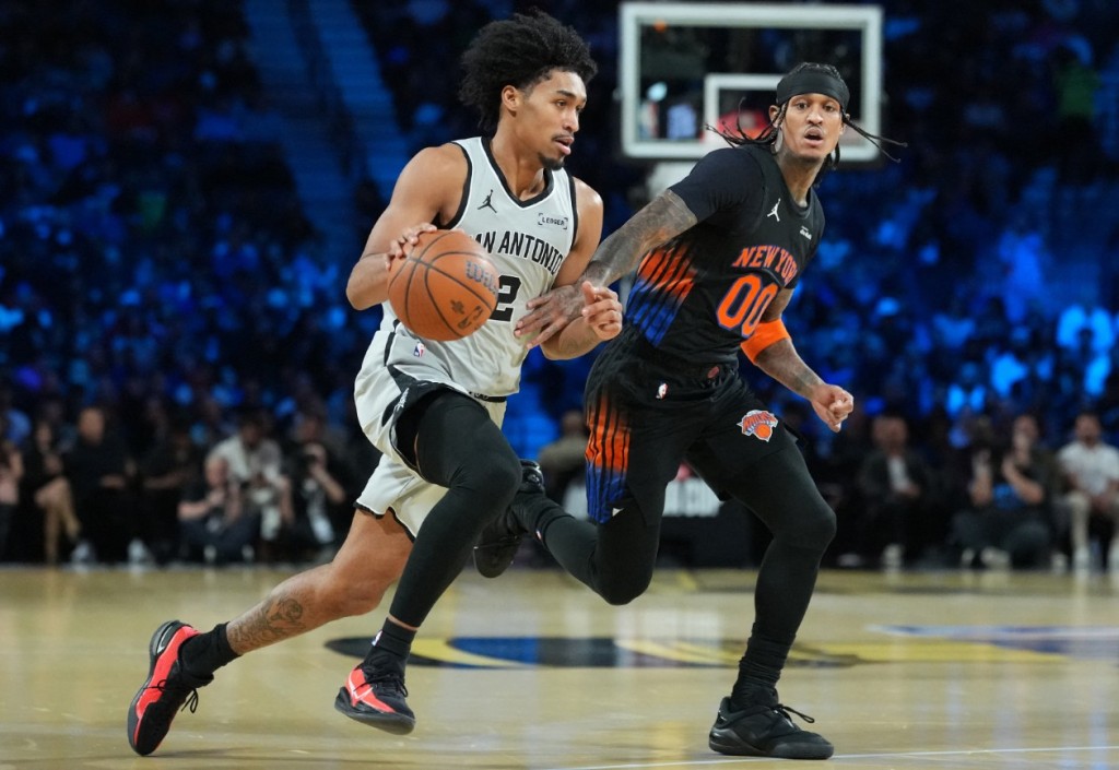 Dylan Harper, left, dribbles past Jordan Clarkson during the NBA Cup final between the San Antonio Spus and New York Knicks in December.  REUTERS 