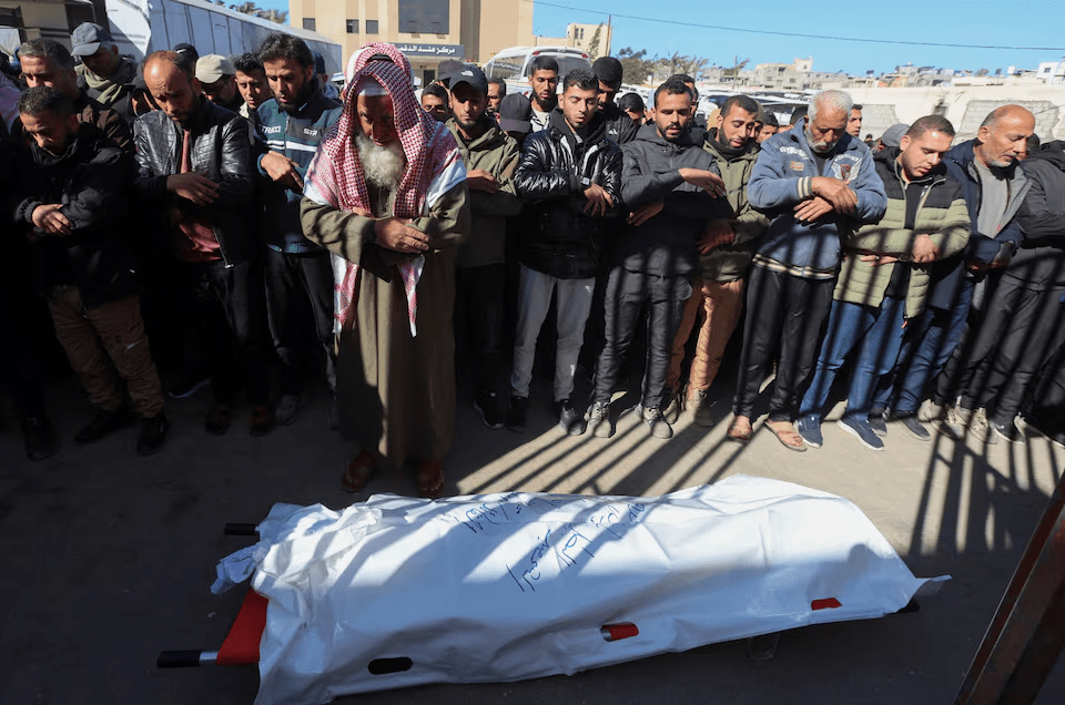 Mourners perform funeral prayers for senior Hamas police officer Mahmoud Al-Astal, who was killed on Monday, at Nasser Hospital in Khan Younis, southern Gaza Strip, January 12, 2026. REUTERS/Ramadan Abed