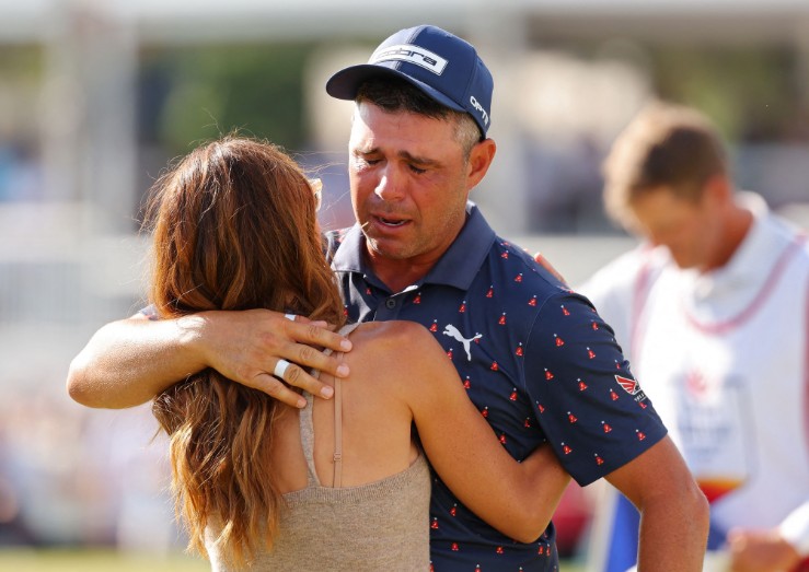 Gary Woodland tears up as he is greeted by his wife Gabby after his final putt at Memorial Park. AFP