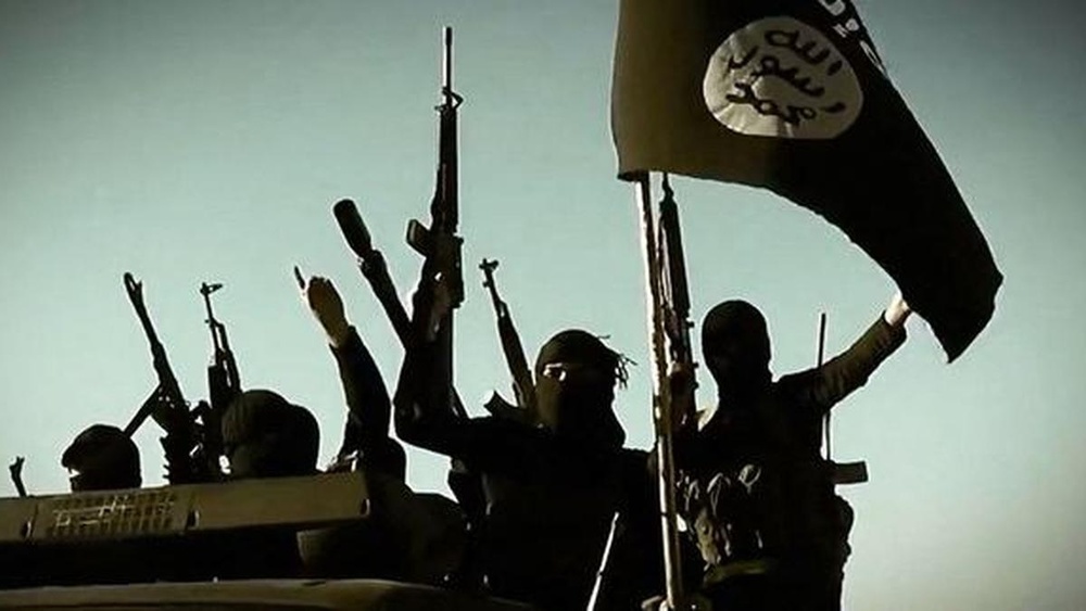 Representational image showing the flag and terrorists of the Islamic State. | Photo Credit: AFP Representational image showing the flag and terrorists of the Islamic State. | Photo Credit: AFP