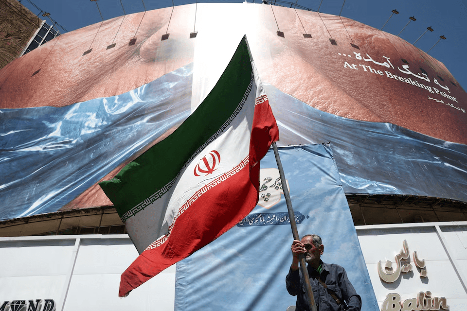 A man holds an Iranian flag in Tehran. Majid Asgaripour/WANA via REUTERS