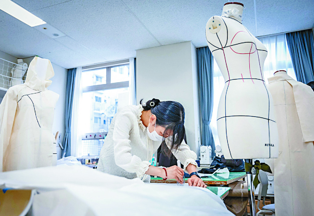 Many designers learn their trade at  Bunka Fashion College but Aya Takeshima, below, right, chose to study abroad to 'learn what I needed to become an independent designer.'  AFP