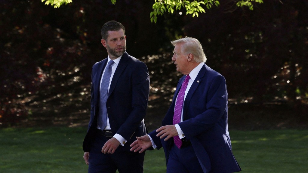 U.S. President Donald Trump speaks with Eric Trump as they walk together to depart the White House in Washington, D.C. Reuters