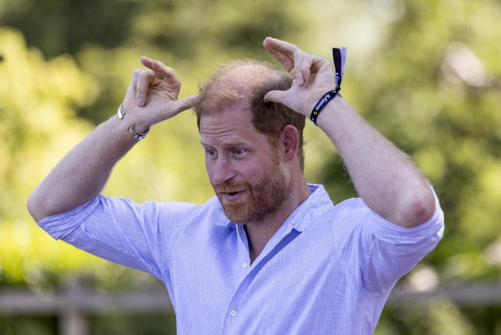 Britain's Prince Harry, Duke of Sussex, reacts as he takes part in a 'Goat Yoga' class as he attends 'Scotty's Summer Festival' at Maxstoke Castle near Birmingham, central England on July 11, 2026. (Photo by Heathcliff O'MALLEY / POOL / AFP)