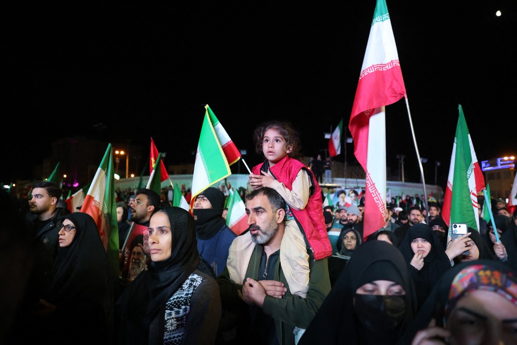 Photo by STR / AFP  Iranians react after a ceasefire announcement at the Enqelab square, in Tehran, on April 8 2026.