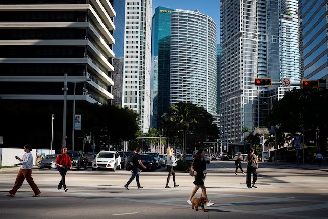 People cross the intersection of SW 8th Steet and Brickell Ave. at the Brickell neighborhood, known as the financial district, in Miami, Florida, U.S., February 23, 2023. (Reuters) People cross the intersection of SW 8th Steet and Brickell Ave. at the Brickell neighborhood, known as the financial district, in Miami, Florida, U.S., February 23, 2023. (Reuters)
