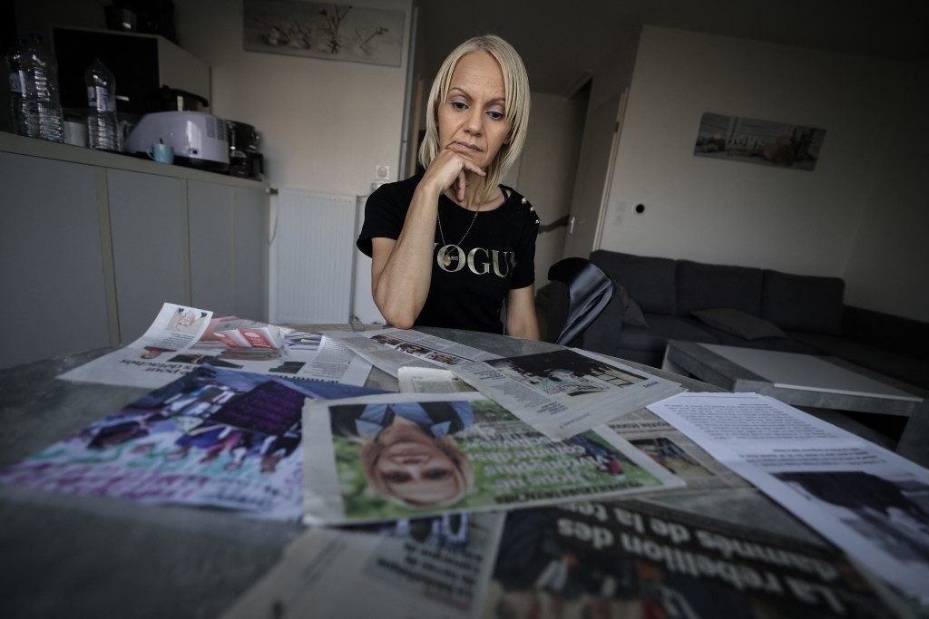Moroccan-born Yasmina Tellal, a 42-year-old Moroccan woman, consults press clippings in south-western France on August 15, 2025.  (Photo by Valentine CHAPUIS / AFP)