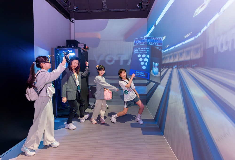 The children thoroughly enjoy the 360° VR bowling experience.