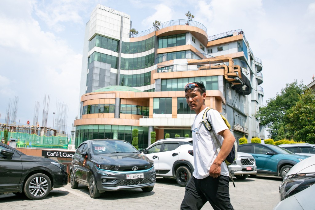 Photo by PRABIN RANABHAT / AFP Karma Gyalje Sherpa, an Everest guide and a relative of mountaineer Dawa Sherpa, arrives to speak to the media outside HAMS Hospital in Kathmandu on June 5, 2026.