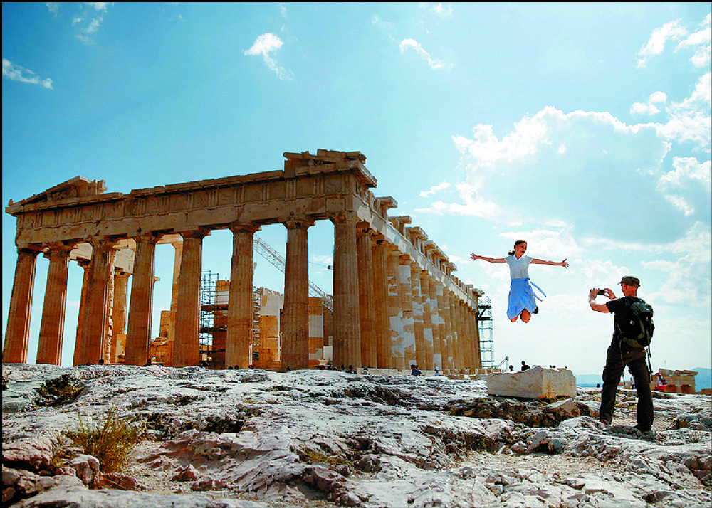 Tourists make sure they remember their time at the Parthenon temple atop Acropolis hill. REUTERS Tourists make sure they remember their time at the Parthenon temple atop Acropolis hill. REUTERS