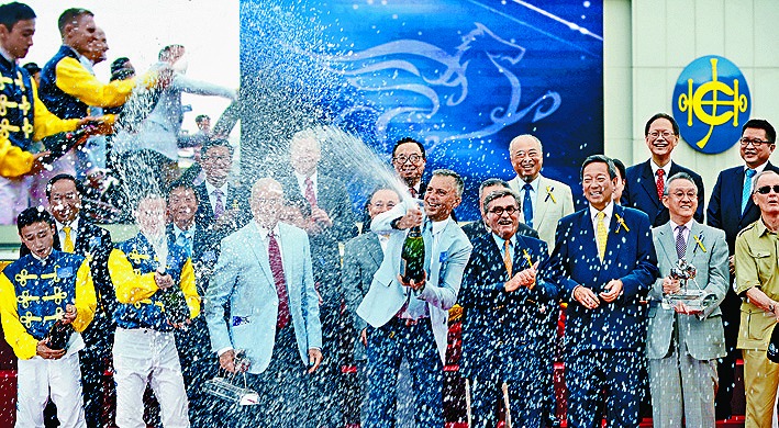 On the final day of the 2014 racing season, Fownes captured the Champion Trainer title and celebrated with his father, Lawrie Fownes, front row, third left.