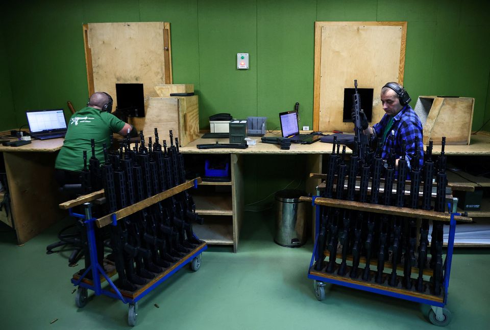 A worker checks the quality of GROT C16 FB-M1, modular assault rifle system. (Reuters)  Workers check the quality of firing of GROT C16 FB-M1, modular assault rifle system at PGZ (Polska Grupa Zbrojna) arms factory. (Reuters) 