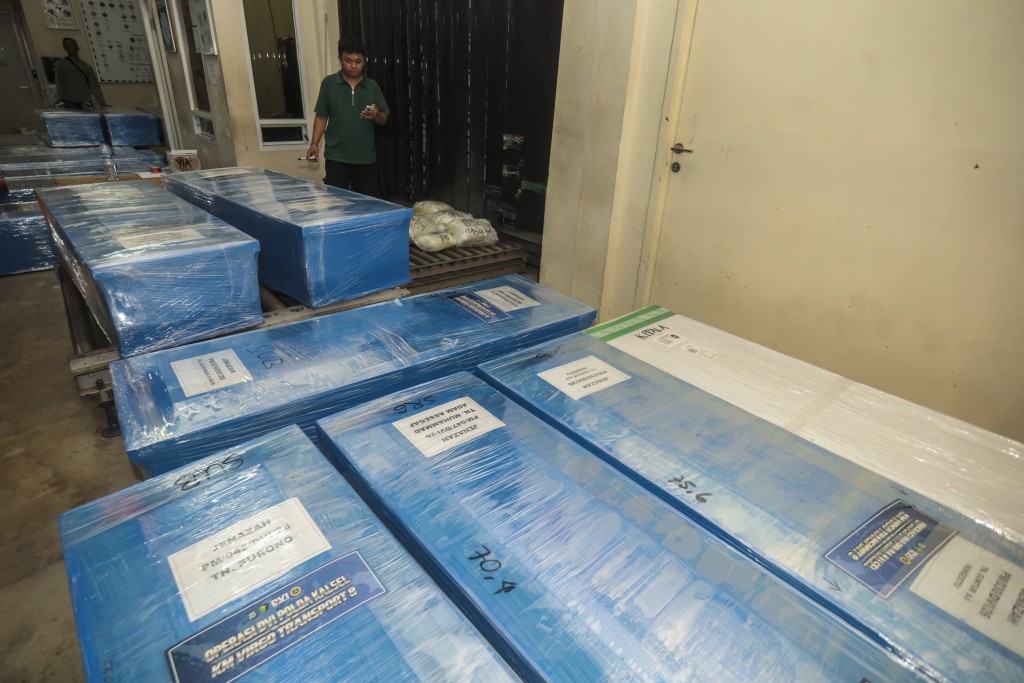 Photo by MUDA SAGALA / AFP  Coffins containing the identified remains of victims from the Virgo 8 ship disaster are prepared for repatriation to their respective hometowns at Syamsudin Noor Airport in Banjarbaru, South Kalimantan province, Indonesia on September 28, 2026.