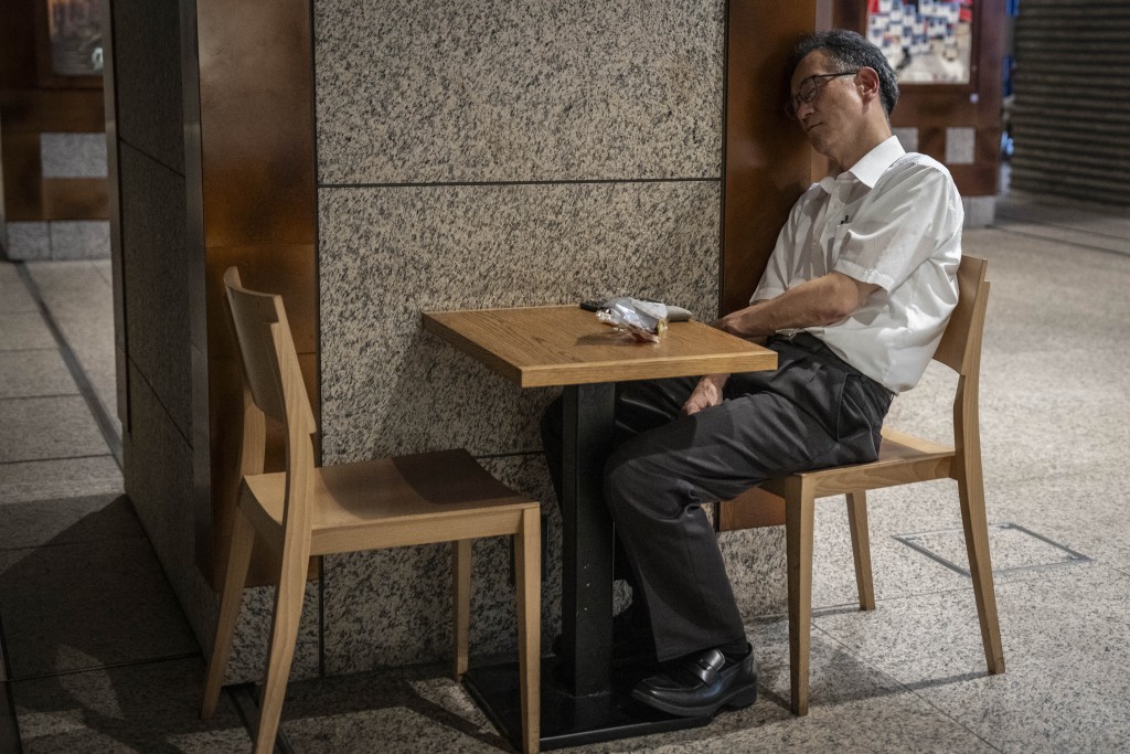 Photo by YUICHI YAMAZAKI / AFP  A man sleeps on a chair inside a commercial facility in Tokyo on September 1, 2026.
