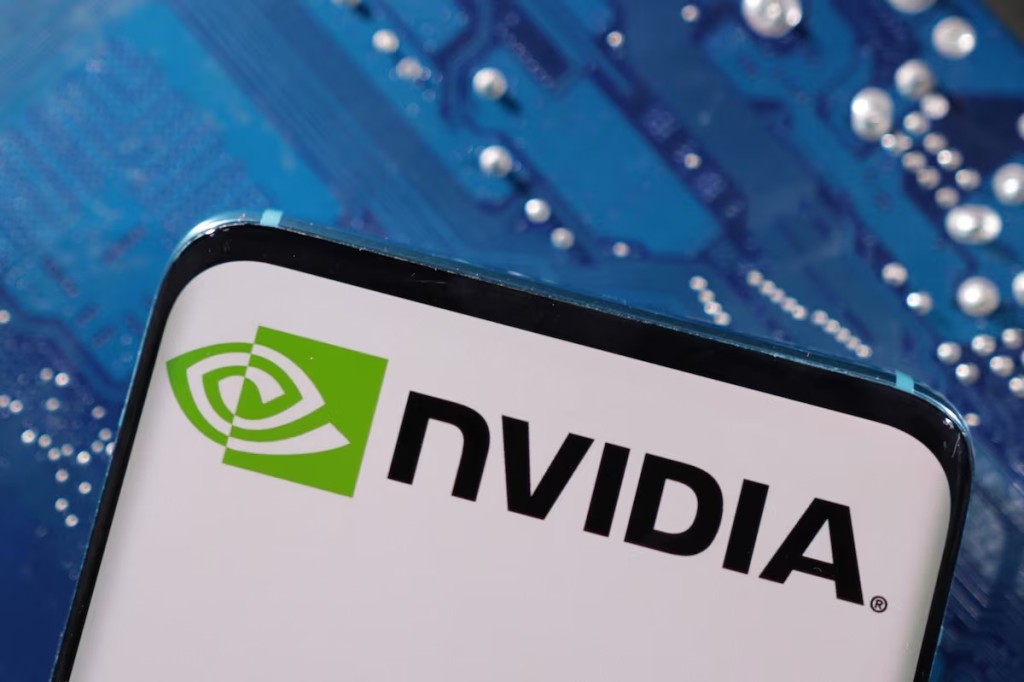 A smartphone with a displayed NVIDIA logo is placed on a computer motherboard in this illustration taken March 6, 2023. REUTERS