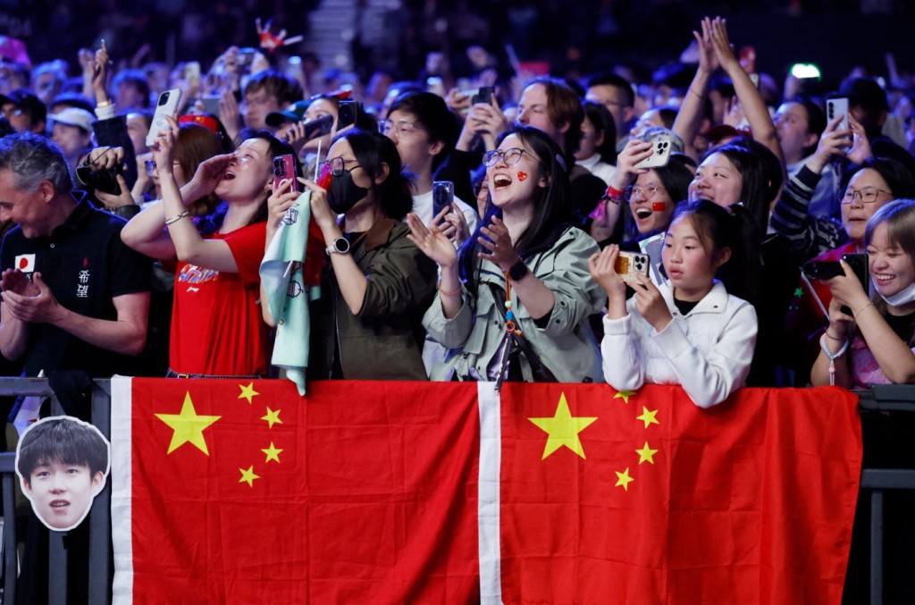 Team China fans celebrate during the World Team Table Tennis Championships in London.  REUTERS