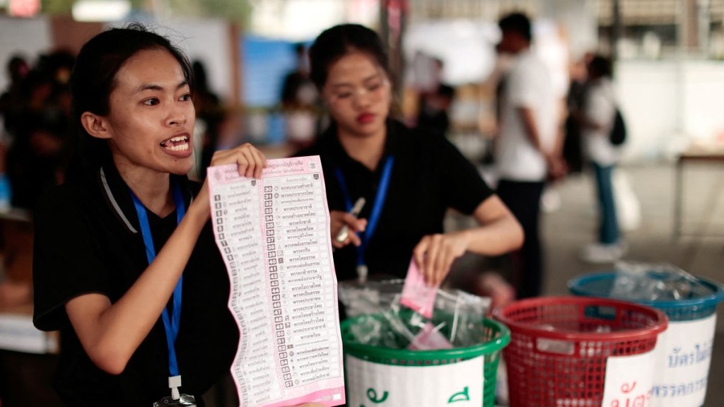 An electoral official shows a ballot during the vote count on the day of the general election, at a polling station in Bangkok. Reuters