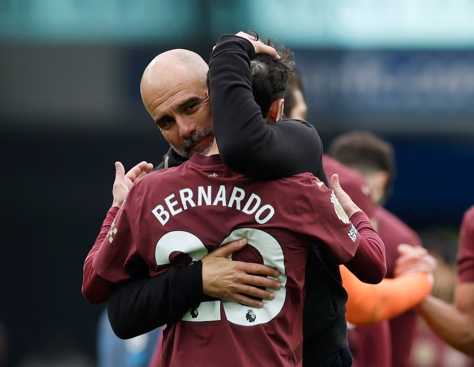 Manchester City manager Pep Guardiola and Bernardo Silva celebrate after the match. (Reuters)