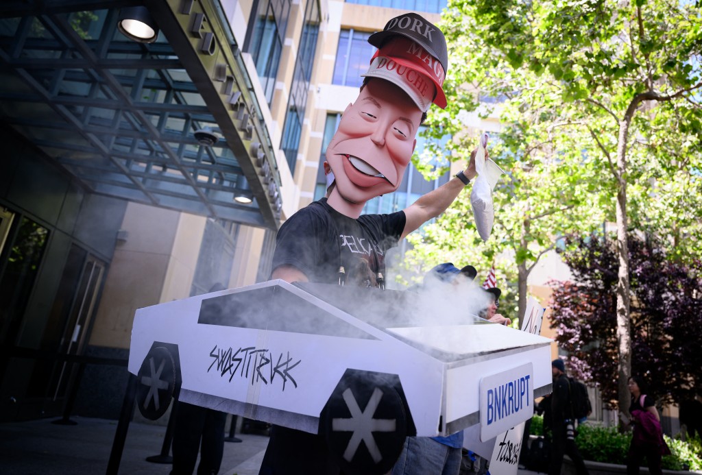 Photo by JOSH EDELSON / AFP  AI protesters chant outside the federal courthouse during proceedings in the trial of Elon Musk VS. OpenAI in Oakland, California, on May 12, 2026.