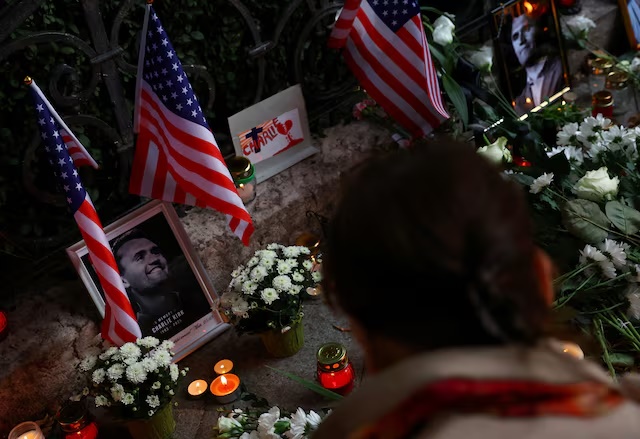 Pictures of conservative activist Charlie Kirk, who was was fatally shot during an event at Utah Valley University, sit amid flowers during a vigil in front of the U.S. Embassy in Budapest, Hungary, September 18, 2025. REUTERS/Bernadett Szabo