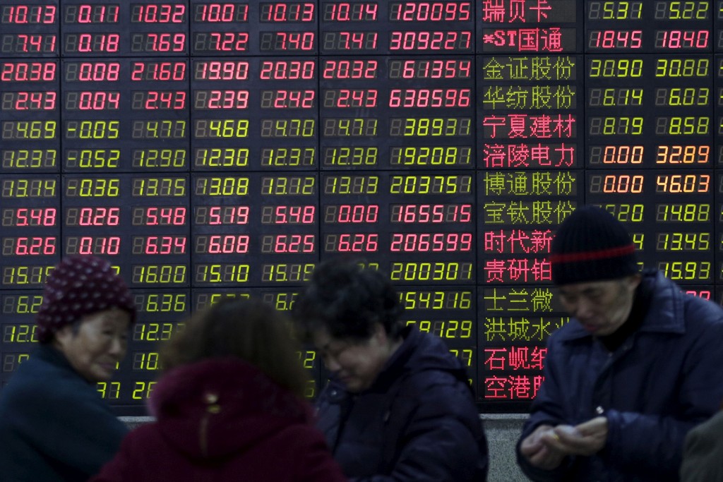 Investors stand in front of an electronic board showing stock information on the first trading day after the week-long Lunar New Year holiday at a brokerage house in Shanghai, China, February 15, 2016. China stocks opened more than 2 percent lower on Monday, as they played catch-up with bearish global markets after the week-long Lunar New Year holiday. REUTERS